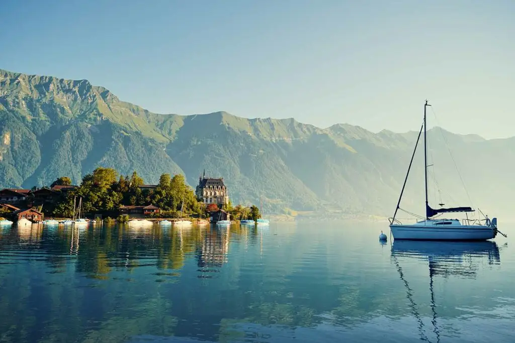 Iseltwald vilage in Lake Brienz with a boat and castle