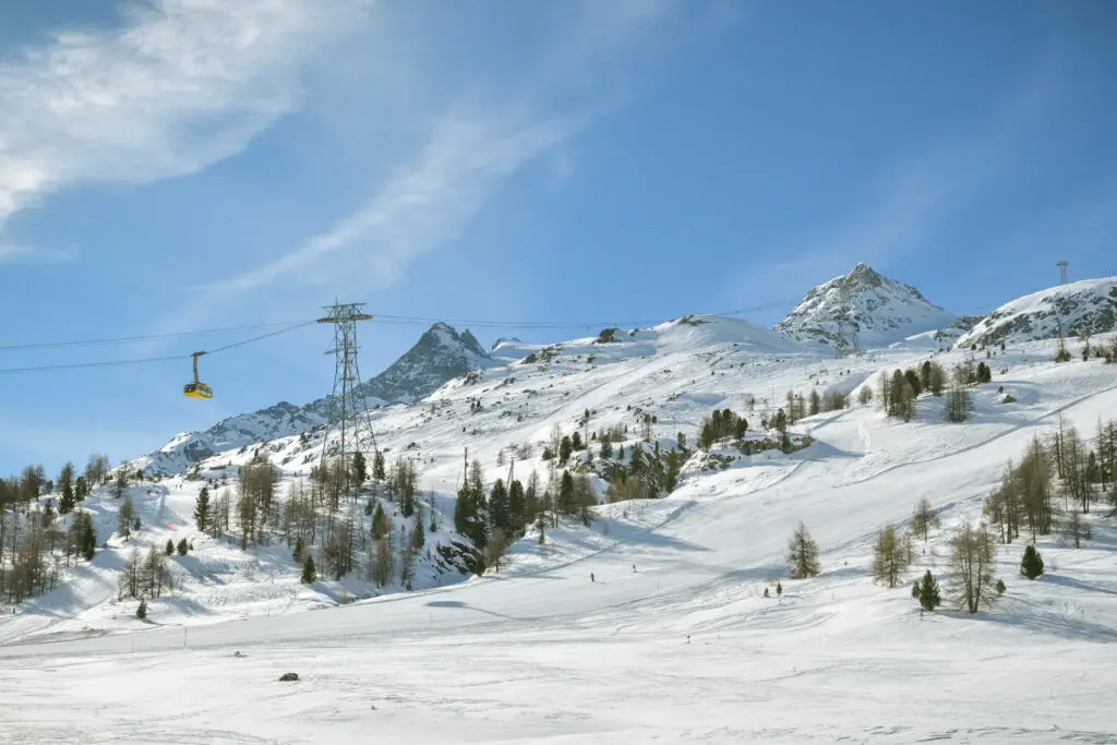 Pontresina, Switzerland - Cable car advancing towards Diavolezza in Diavolezza skiing resort close the popular St. Moritz in Swiss Alps during peak winter
